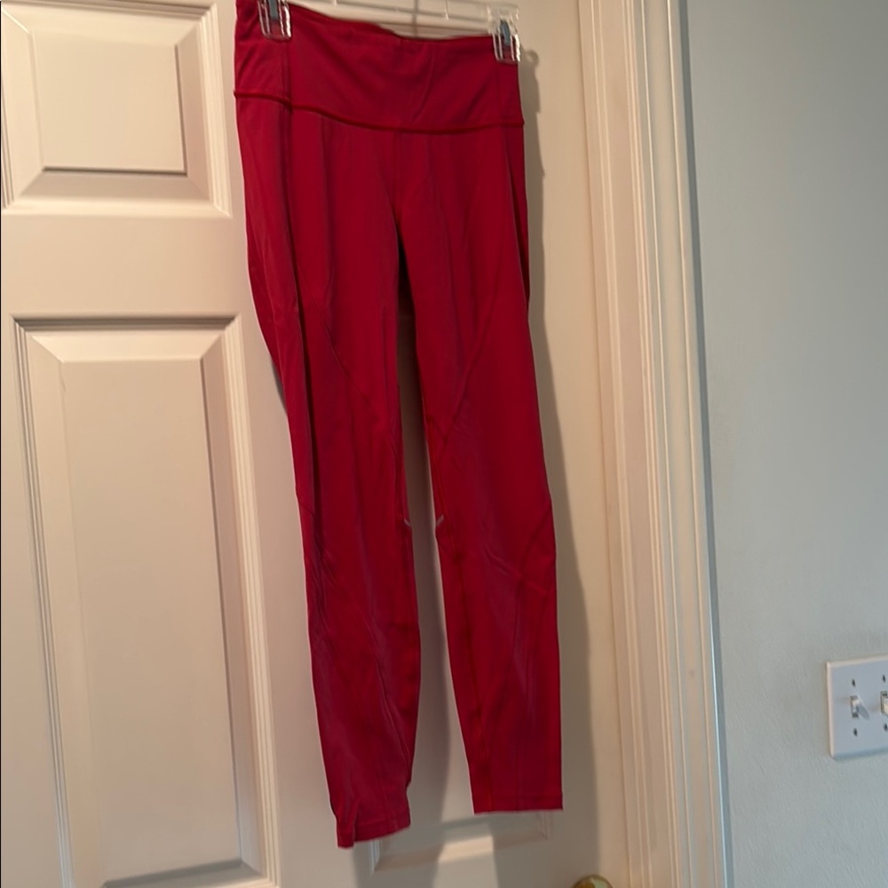 Lululemon ankle length red running leggings.